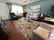 Well decorated living room with stylish furniture, floral rug, and natural light at 1235 S Highland Ave # 1-204, Clearwater, FL 33756