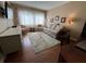 Comfortable living room features light-filled window views, floral sofa and rug, and hardwood floors at 1235 S Highland Ave # 1-204, Clearwater, FL 33756