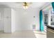 Dining area with white walls, floors, and cabinets, a sliding glass door, and a ceiling fan at 12400 Park Blvd # 524, Seminole, FL 33772