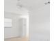 Neutral-colored room with light walls and floors, a ceiling fan, and a small storage unit at 12400 Park Blvd # 524, Seminole, FL 33772