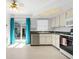 Bright kitchen area with a stainless steel dishwasher, dark counters, and a sliding glass door at 12400 Park Blvd # 524, Seminole, FL 33772