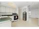 Bright kitchen area with modern appliances, light-colored cabinets, and an adjacent sitting room at 12400 Park Blvd # 524, Seminole, FL 33772