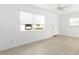 Living room with light-colored walls and floors, a ceiling fan, and two windows that stream natural light at 12400 Park Blvd # 524, Seminole, FL 33772
