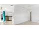 Open floorplan with light walls and floors, a kitchen, and access to a screened-in patio at 12400 Park Blvd # 524, Seminole, FL 33772