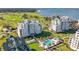 Aerial view of beachfront condos near a golf course and ocean at 125 Belleview Blvd # 303, Belleair, FL 33756