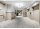 Well-lit hallway featuring neutral tones, wainscoting, carpet, and stylish lighting fixtures at 125 Belleview Blvd # 303, Belleair, FL 33756