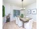 Inviting dining room featuring a modern light fixture and a large window, perfect for gatherings at 13225 Royal George Ave, Odessa, FL 33556