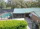 Aerial view of a backyard pool with screened enclosure and lush landscaping at 13607 Mcintosh Rd, Thonotosassa, FL 33592