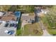 An aerial view of a quaint single-Gathering home featuring a well-manicured lawn, long driveway and neighboring pool at 1515 W Lambright St, Tampa, FL 33604