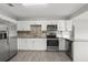 Bright kitchen with stainless steel appliances, white cabinetry, and modern countertops at 1515 W Lambright St, Tampa, FL 33604