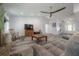 Living room showcasing an open concept design, stone fireplace, gray floors, and lots of natural light at 16740 Monteverde Dr, Spring Hill, FL 34610