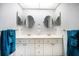 Bright bathroom features dual sinks, modern fixtures, and plenty of storage space in vanity cabinets at 18 Crescent S Pl, St Petersburg, FL 33711