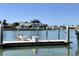 Well-maintained private dock with clear water views and serene waterfront homes in the distance at 18 Crescent S Pl, St Petersburg, FL 33711