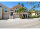 Elegant townhome with two-car garage, landscaped front yard, and charming architectural details at 18 Crescent S Pl, St Petersburg, FL 33711