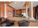 Kitchen bar with granite counters and wooden cabinets featuring stainless steel appliances for modern convenience at 18 Crescent S Pl, St Petersburg, FL 33711
