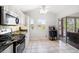 Bright kitchen with stainless appliances, tiled floor, and sliding doors to the patio at 18 Crescent S Pl, St Petersburg, FL 33711