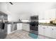 Well-lit kitchen with stainless steel appliances, granite countertops, and white cabinetry at 18 Crescent S Pl, St Petersburg, FL 33711