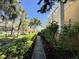 Beautifully landscaped pathway leading to the property with lush greenery and mature trees at 18 Crescent S Pl, St Petersburg, FL 33711