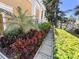 Lush landscaping showcasing colorful plants and manicured hedges along the side of the building at 18 Crescent S Pl, St Petersburg, FL 33711