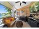 Inviting outdoor patio with comfortable seating, TV, and scenic lake views at 18 Crescent S Pl, St Petersburg, FL 33711