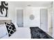 A bedroom with white walls, gray doors, and art at 18530 Gulf Blvd, Indian Shores, FL 33785