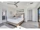 This light-filled bedroom features a gray color scheme with wood accents and luxury vinyl flooring at 18530 Gulf Blvd, Indian Shores, FL 33785