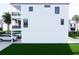 Side view of the property, highlighting its clean lines, ample parking, and outdoor space at 18530 Gulf Blvd, Indian Shores, FL 33785
