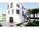 Home featuring an exterior stairway, dark trim, and a spacious two-car garage at 18530 Gulf Blvd, Indian Shores, FL 33785