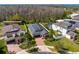 Aerial view of a home featuring a brick driveway, lush landscaping, and a well-maintained lawn at 19476 Paddock View Dr, Tampa, FL 33647