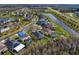 Aerial view of homes in a neighborhood alongside a picturesque pond and a highway at 19476 Paddock View Dr, Tampa, FL 33647
