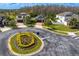Neighborhood aerial view with brick driveways, landscaping, and circular flower garden at 19476 Paddock View Dr, Tampa, FL 33647