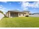 Large backyard with a well-maintained lawn and screened patio at 19476 Paddock View Dr, Tampa, FL 33647