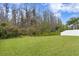 Beautifully maintained backyard featuring a lush green lawn and a white vinyl fence for added privacy and security at 19476 Paddock View Dr, Tampa, FL 33647