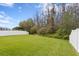 Lush backyard with a beautiful lawn and white vinyl fence offering a serene and private outdoor space at 19476 Paddock View Dr, Tampa, FL 33647