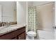 Bathroom with granite countertop vanity and shower with palm tree shower curtain at 19476 Paddock View Dr, Tampa, FL 33647