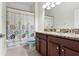 Well-lit bathroom featuring a granite countertop vanity and a shower with curtain at 19476 Paddock View Dr, Tampa, FL 33647