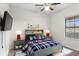 Bedroom featuring stylish decor, a ceiling fan, and a window with blinds at 19476 Paddock View Dr, Tampa, FL 33647