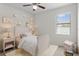 Cozy bedroom with a ceiling fan, a window and stylish decorations at 19476 Paddock View Dr, Tampa, FL 33647