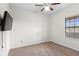 Bright bedroom with a ceiling fan and a window with blinds at 19476 Paddock View Dr, Tampa, FL 33647