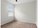 A simple, empty bedroom with carpet flooring and natural light at 19476 Paddock View Dr, Tampa, FL 33647