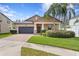 Attractive single-Gathering home with a brick driveway, well-maintained lawn, and mature trees at 19476 Paddock View Dr, Tampa, FL 33647