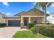 Inviting one-story home featuring a brick walkway, covered porch, and lush landscaping at 19476 Paddock View Dr, Tampa, FL 33647