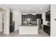 Modern kitchen featuring dark cabinets, granite countertops, stainless steel appliances, and center island at 19476 Paddock View Dr, Tampa, FL 33647