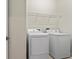 Laundry room featuring a washer, a dryer, and shelving at 19476 Paddock View Dr, Tampa, FL 33647