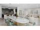 Stylish open-concept living space with modern dining set, comfortable seating, and sleek kitchen at 19476 Paddock View Dr, Tampa, FL 33647