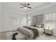 A well-lit main bedroom with large bed, neutral colors, tray ceiling, ceiling fan, and lots of natural light at 19476 Paddock View Dr, Tampa, FL 33647