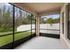 Relaxing screened patio with seating and views of the fenced backyard at 19476 Paddock View Dr, Tampa, FL 33647