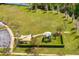 Community playground with safe, enclosed play area, shade, and open green space at 19476 Paddock View Dr, Tampa, FL 33647