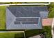 Aerial view of the roof featuring solar panels, surrounded by well-maintained lawn and landscaping at 19476 Paddock View Dr, Tampa, FL 33647