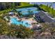 Aerial view of community amenities including tennis courts, pool, and a spacious clubhouse at 19476 Paddock View Dr, Tampa, FL 33647